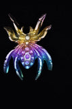 Colorful insect-like figurine on a black background