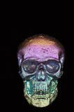 Colorful skull-shaped object on a black background