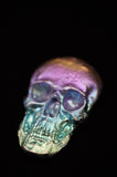 Colorful skull-shaped object on a black background