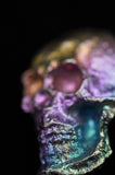 Close-up of a colorful gemstone with a dark background