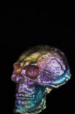 Close-up of a metallic object with iridescent colors on a black background