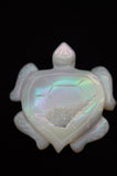 Opal turtle pendant on a black background