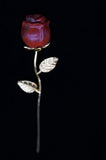 Red rose pendant with gold leaves on a black background